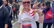 Person holds medal after completing race